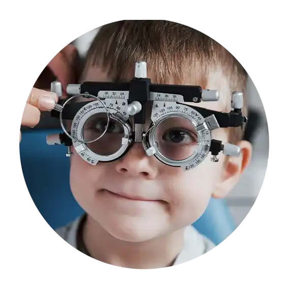 Child wearing trial frames for a pediatric eye exam